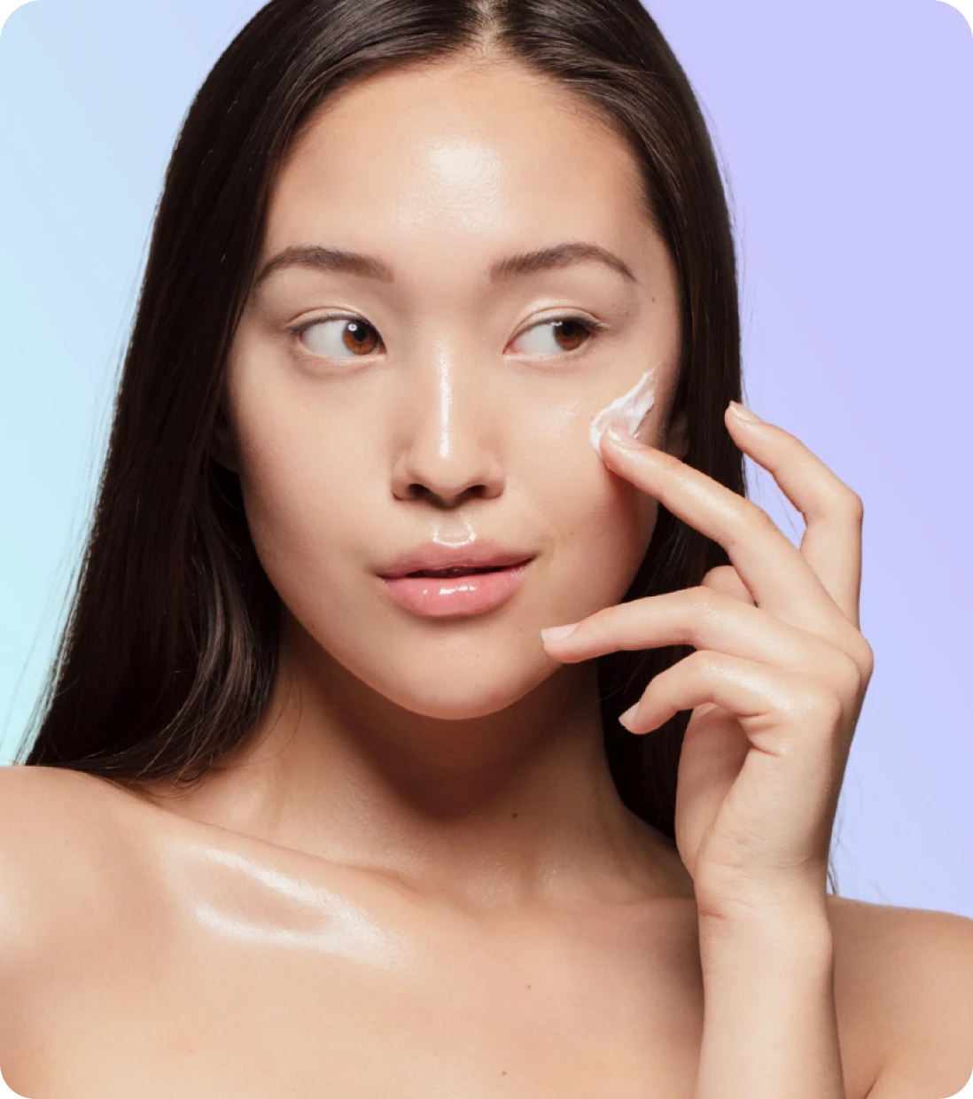 Woman applying Brightvue skincare to her cheek